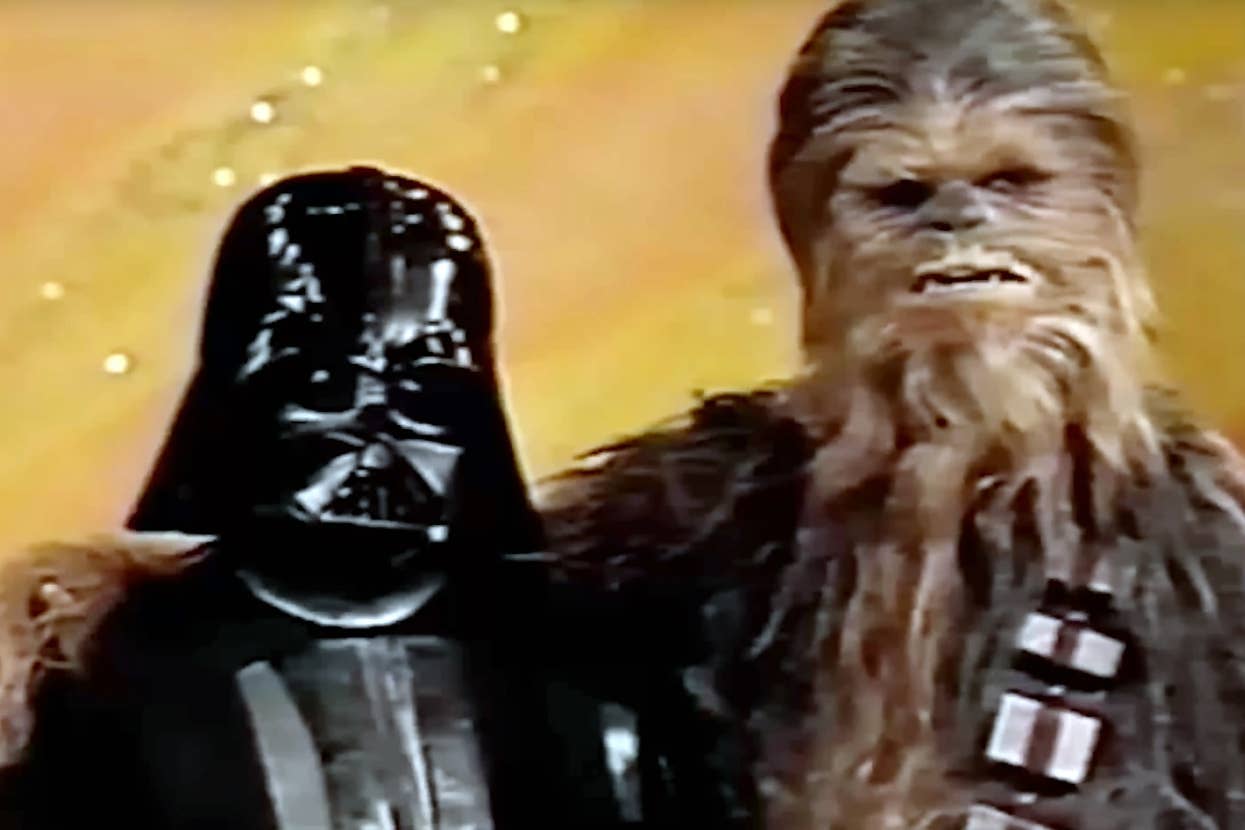 Vader and Chewy with their arms around each other.