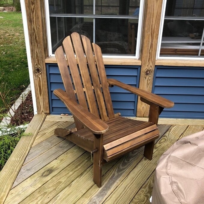 Wooden Adirondack chair on outdoor deck, showcasing potential furniture for patio shopping