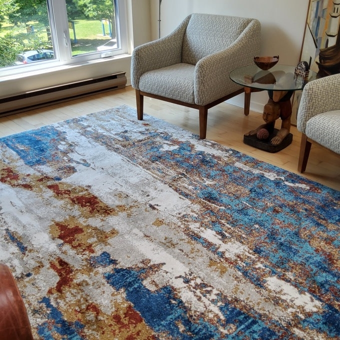 Area rug with a modern abstract design in a living room setting, essential for home decor ideas