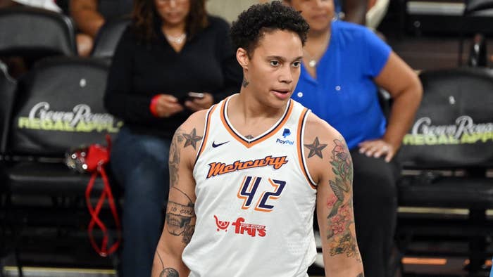 Brittney Griner in basketball uniform on court, focused, tattoos visible