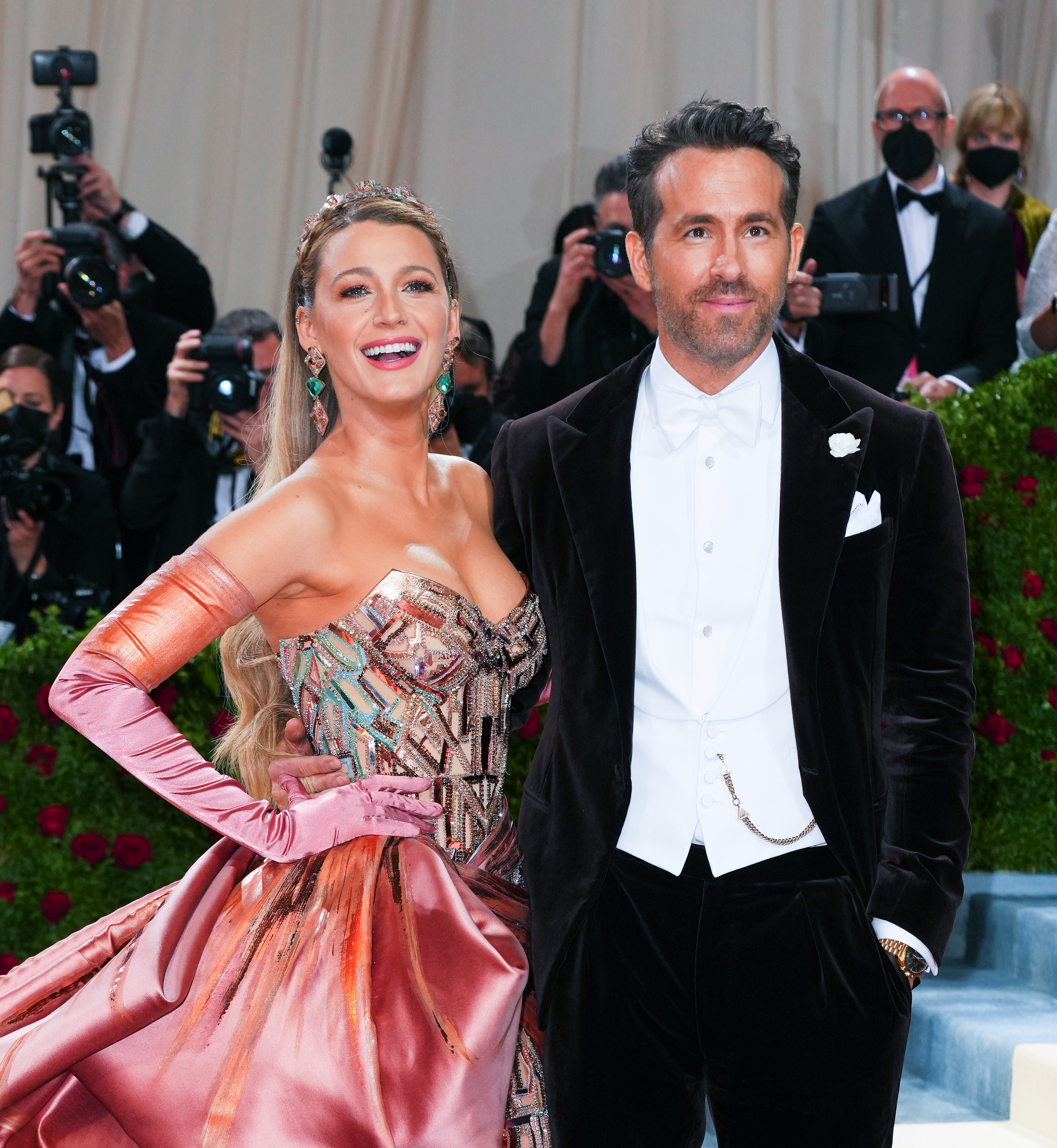 Blake Lively in a metallic gown with Ryan Reynolds in a velvet suit on the red carpet