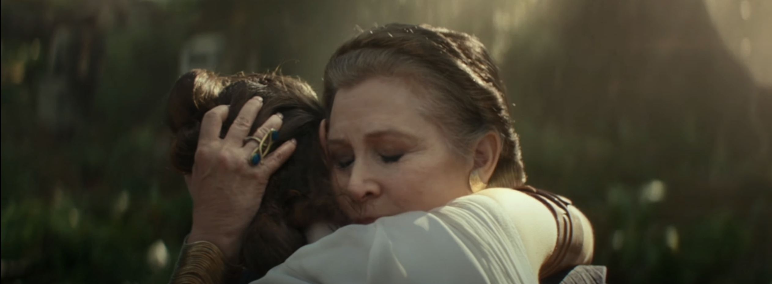 Leia Organa embracing Wookiee Chewbacca in a scene from a Star Wars film
