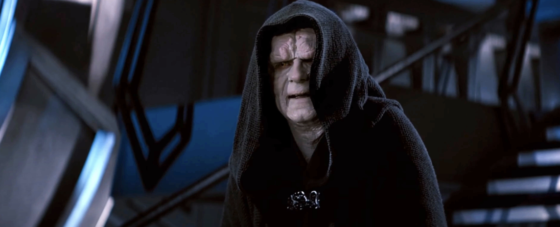 Emperor Palpatine from Star Wars in dark hooded robe, standing in dimly lit room