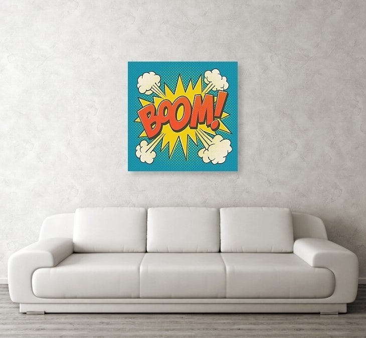 &quot;Pop art style &#x27;BOOM!&#x27; poster above a white sofa in a simple living room setup, suitable for modern home decor.&quot;