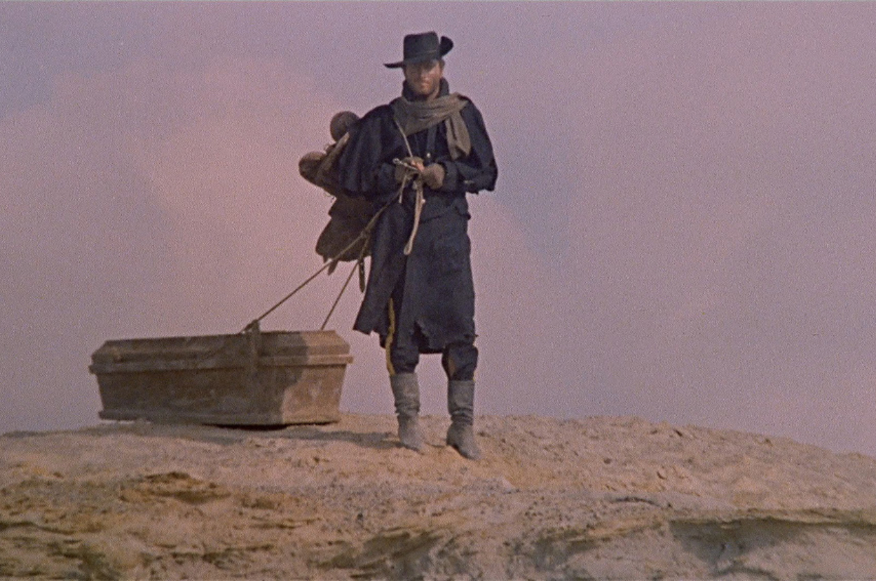 Character from the film &quot;The Good, the Bad and the Ugly&quot; stands with a shovel on a dry landscape