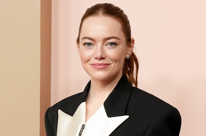 Woman in a tuxedo-style dress with lapels smiles at the camera