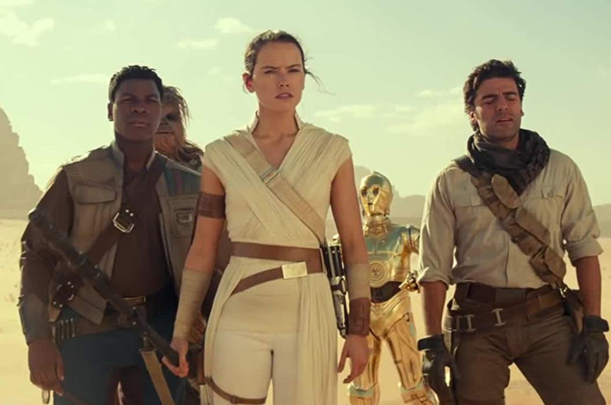 Rey, Finn, and Poe with C-3PO in a desert from Star Wars, wearing character-specific outfits