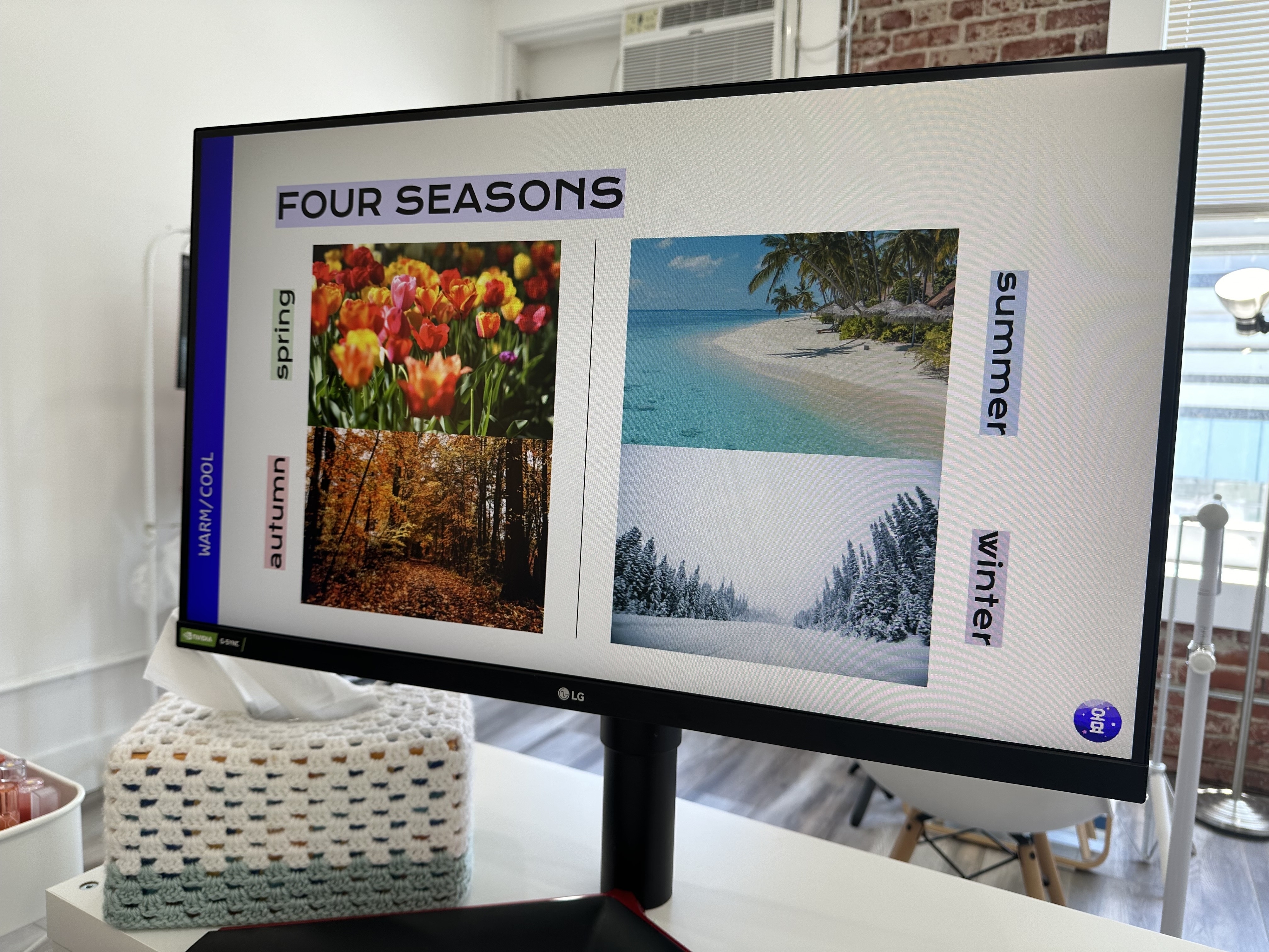 Monitor displaying a presentation on the four seasons with images: tulips for spring, autumn leaves, a beach for summer, and snowy trees for winter