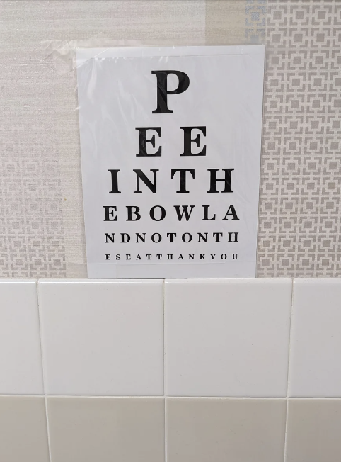 Eye chart-themed sign with the message: &quot;PEE IN THE BOWL AND NOT ON THE SEAT THANK YOU.&quot;