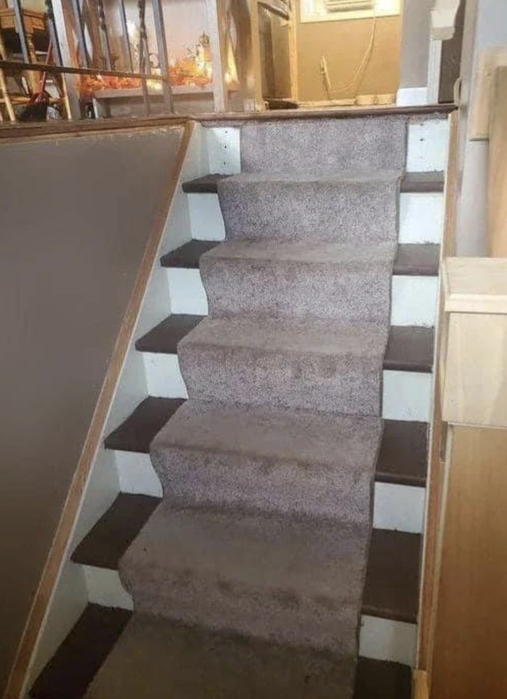 A staircase with uneven, irregular steps leading to an upper level in a house. The steps vary in height and depth, posing a potential tripping hazard