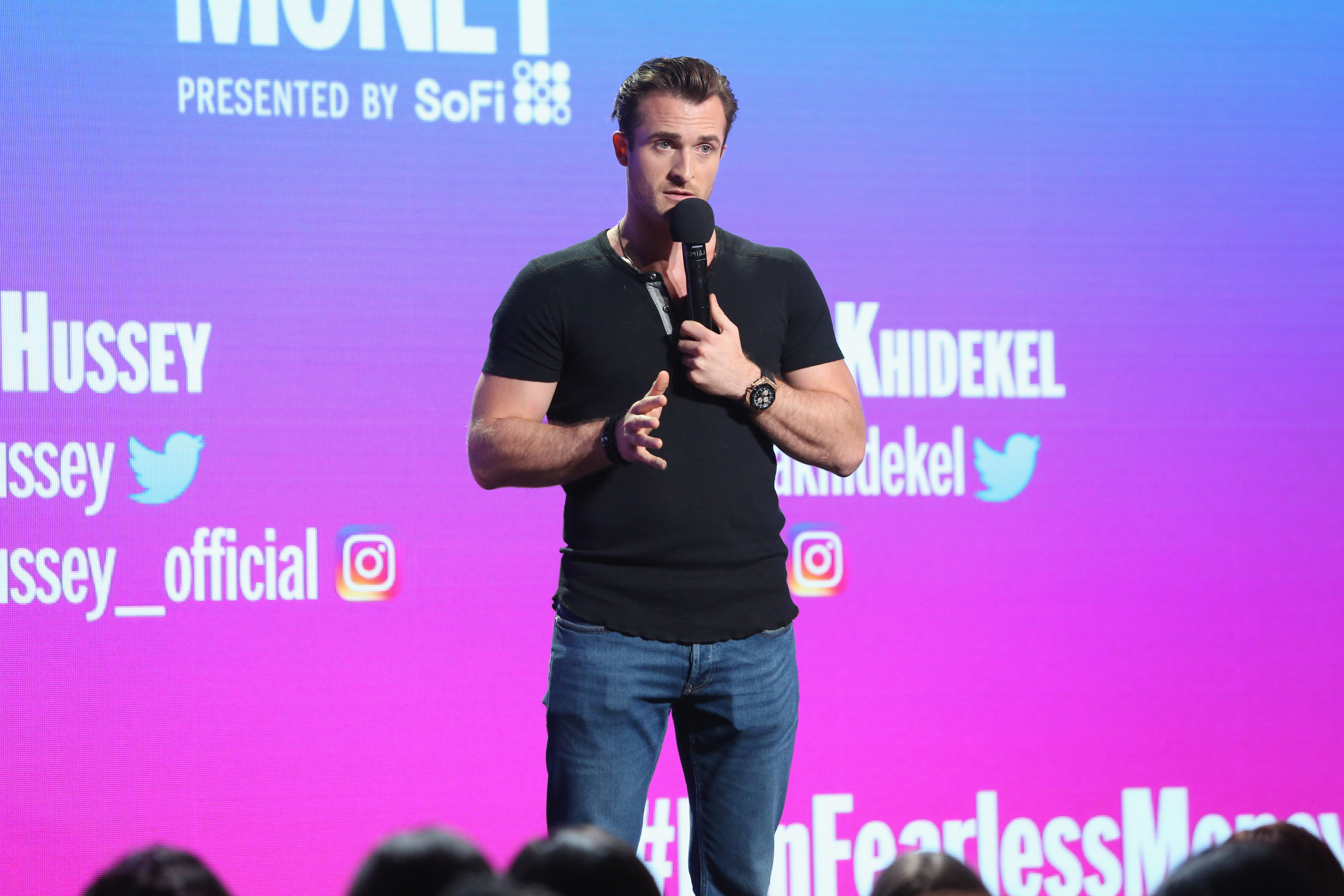 Matthew Hussey speaking on stage at tn event