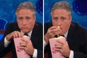 Jon Stewart in a suit, eating popcorn with a surprised expression in a two-panel image