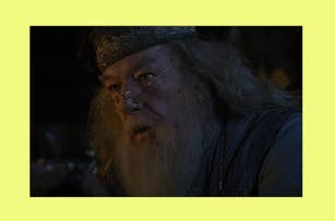 Dumbledore, from Harry Potter, wearing a headpiece and glasses, is shown in a close-up scene