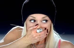 Gwen Stefani covering her mouth in the Hollaback Girl music video
