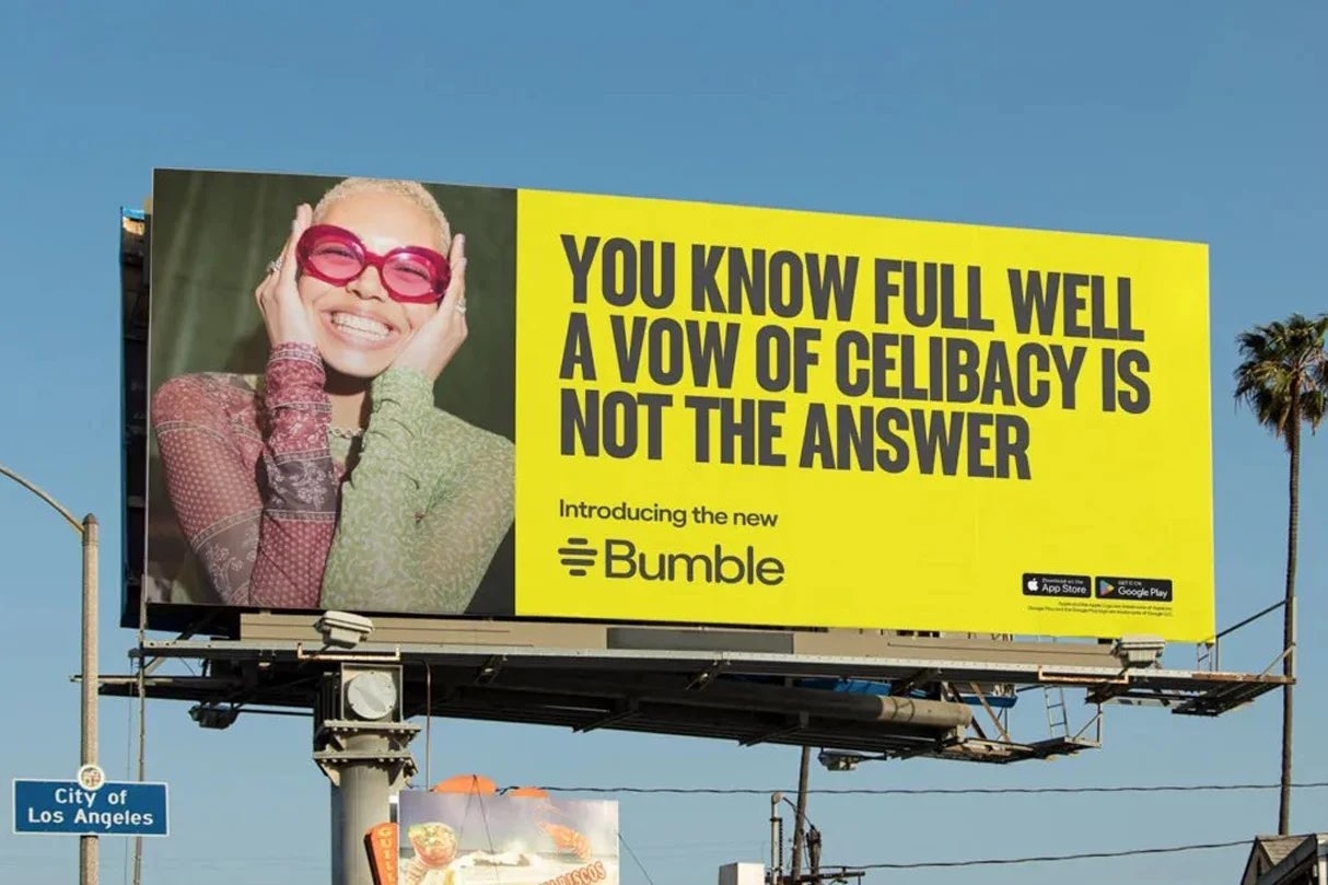 A cheerful person wearing glasses and a sheer top is featured on a billboard with the text: &quot;You know full well a vow of celibacy is not the answer. Introducing the new Bumble.&quot;