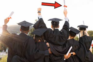 Graduates in caps and gowns raise their diplomas with an arrow pointing to one individual's raised diploma