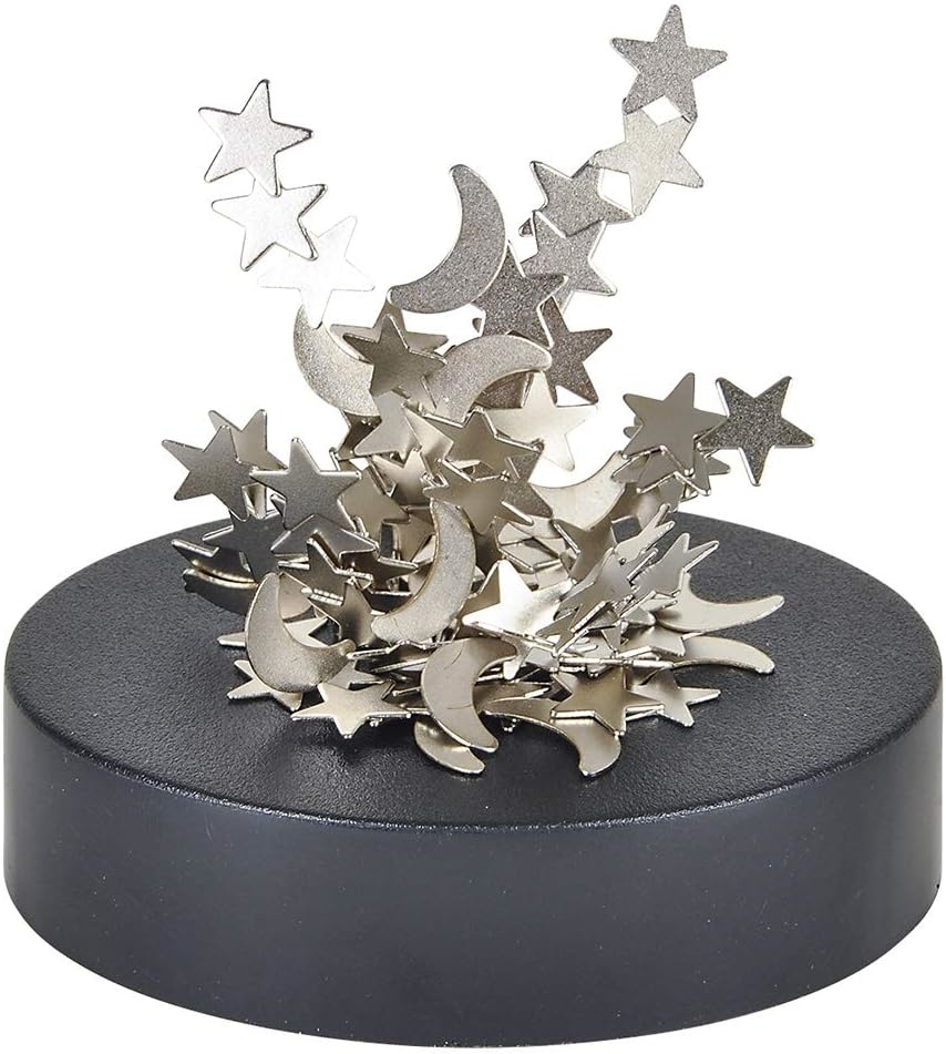 A black base holds a magnetic pile of metal stars and moons appearing to float and balance in various positions