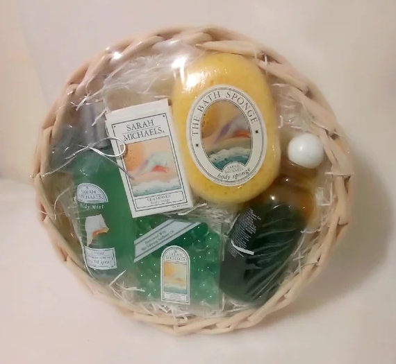 Gift basket with Sarah Michaels body products including a bath sponge, soap, and bath gel