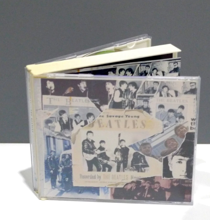 CD case with a collage of photos and text featuring The Beatles, titled &quot;The Savage Young Beatles.&quot;