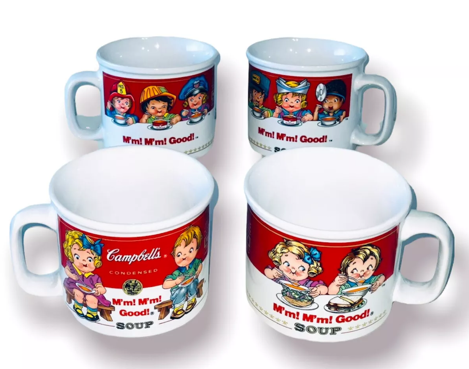 Four white mugs featuring retro Campbell&#x27;s Soup ads with illustrated children enjoying soup, showing phrases &quot;M&#x27;m! M&#x27;m! Good!&quot;