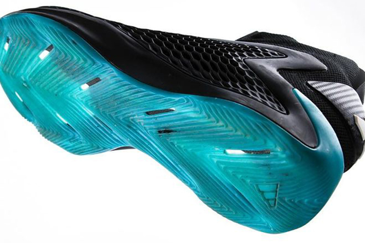 Close-up view of the sole design of a black sneaker with a distinctive blue translucent tread pattern