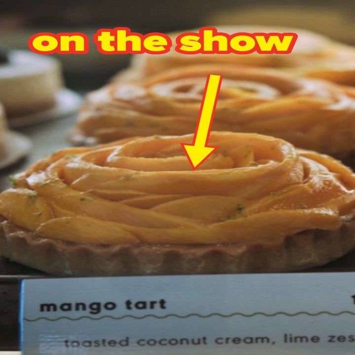 Mango tarts display with rose-shaped mango slices. Sign reads: "mango tart 12, toasted coconut cream, lime zest."
