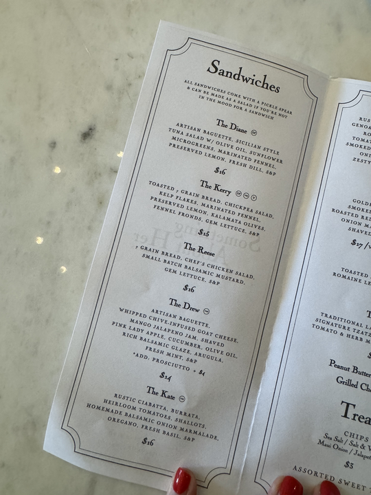 Restaurant menu titled &quot;Sandwiches&quot; lists options like The Dinnie, The Kerry, The Dom, The Dave, The Kate with descriptions of ingredients and prices