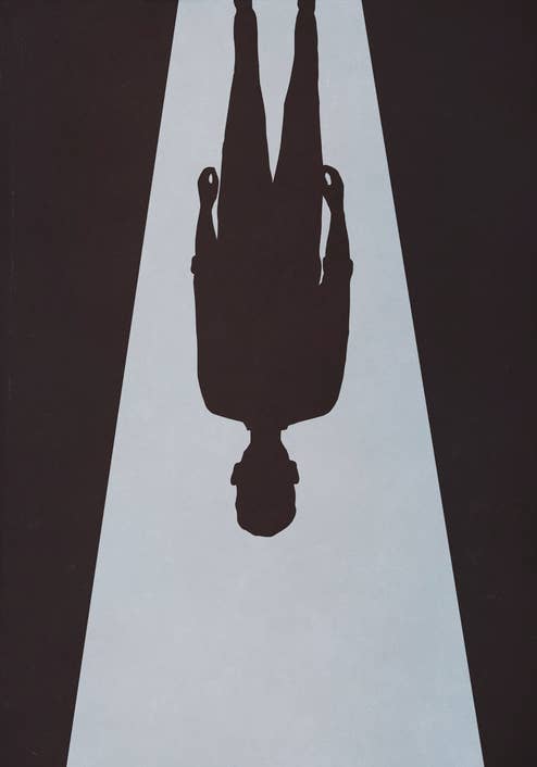 A single person is standing under a spotlight, casting a shadow. The image focuses on the silhouette and doesn't show detailed features
