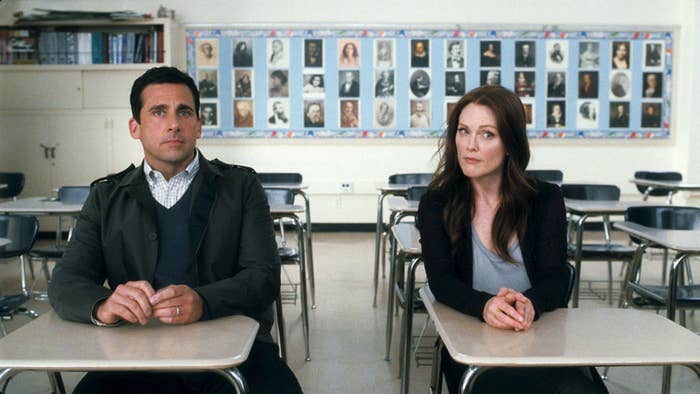 Steve Carell and Julianne Moore sit at separate desks in a classroom, looking towards the front with serious expressions in a scene from "Crazy, Stupid, Love."