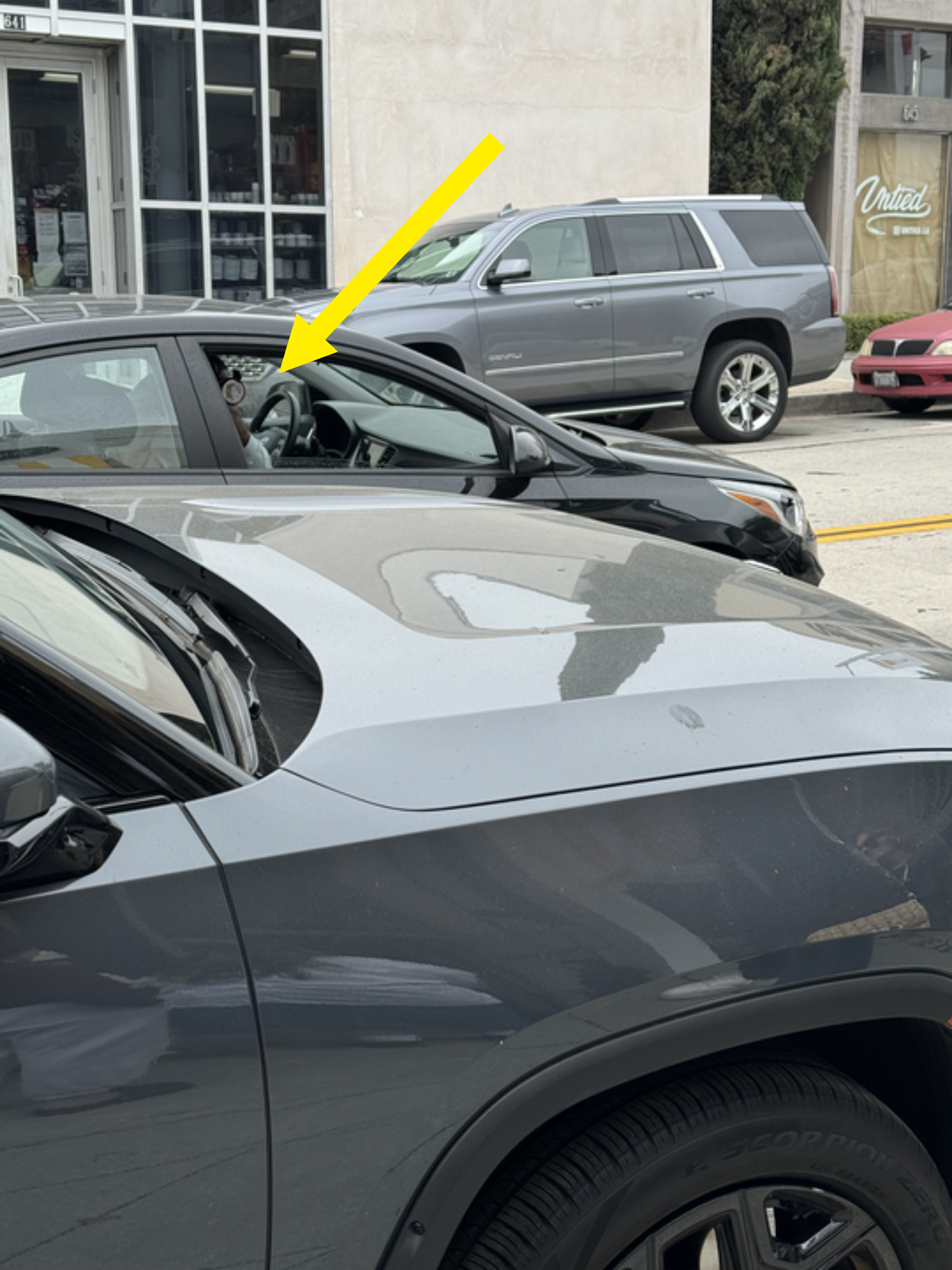 A shot of a man taking paparazzi photos from his car