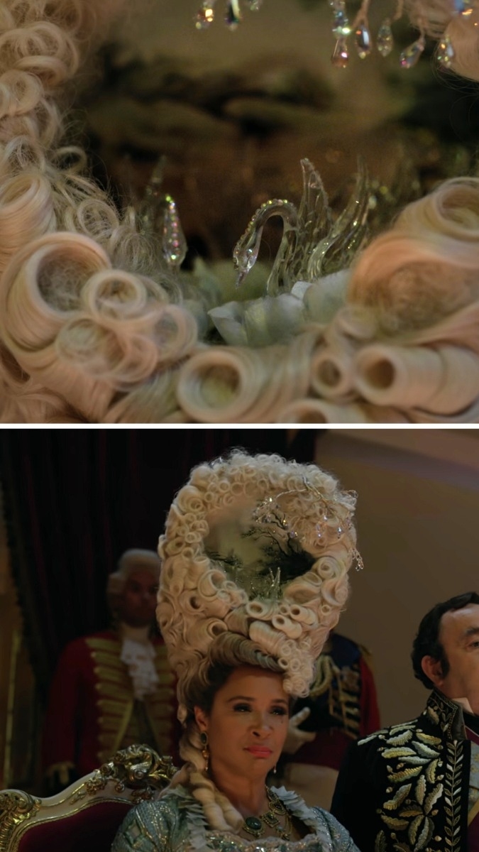 close-up of Charlotte's wig with open center and glass swans inside, Charlotte wearing her opulent wig and a fancy dress while seated