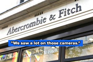 Storefront with "Abercrombie & Fitch" signage above the entrance and rainbow flags displayed in the windows