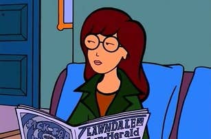 Daria Morgendorffer reads the Lawndale Sun-Herald newspaper while sitting on a couch