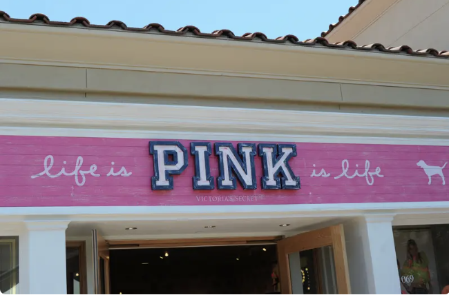 Exterior view of a Victoria's Secret PINK store with a sign reading "life is PINK is life" above the entrance