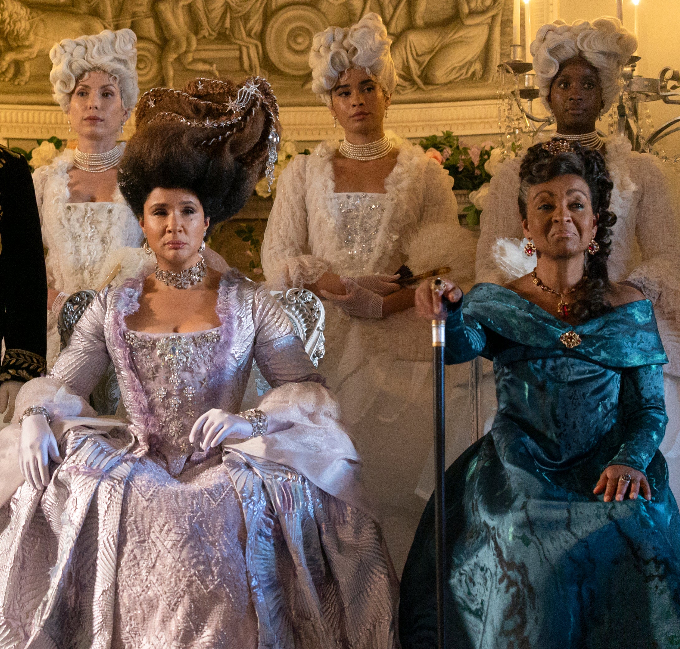 Queen Charlotte and Lady Agatha Danbury in extravagant gowns and elegant wigs