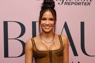 Cassie attends a Hollywood Reporter event, wearing a structured bodice top and a long skirt, holding a black clutch purse, and sporting a high bun hairstyle