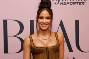 Cassie attends a Hollywood Reporter event, wearing a structured bodice top and a long skirt, holding a black clutch purse, and sporting a high bun hairstyle