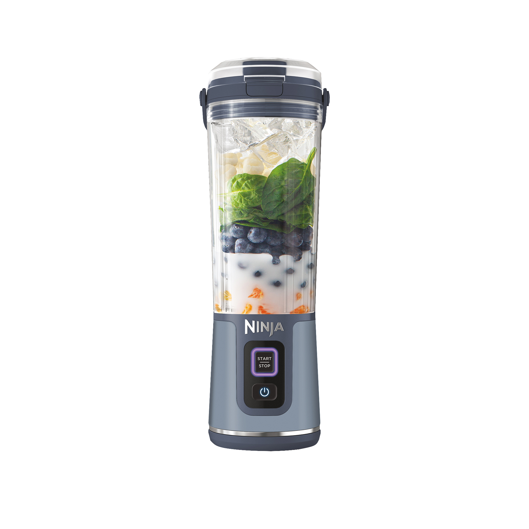 A Ninja blender filled with milk, blueberries, spinach, ice, and orange fruit pieces