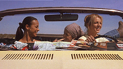 Zoe Saldana, Taryn Manning, and Britney Spears share a laugh inside a convertible while on a road trip in a scene from the movie "Crossroads."
