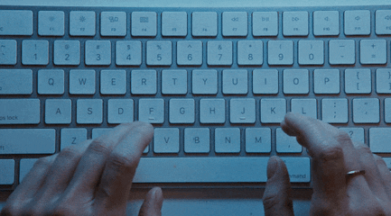 Indecisive hands hover over a keyboard