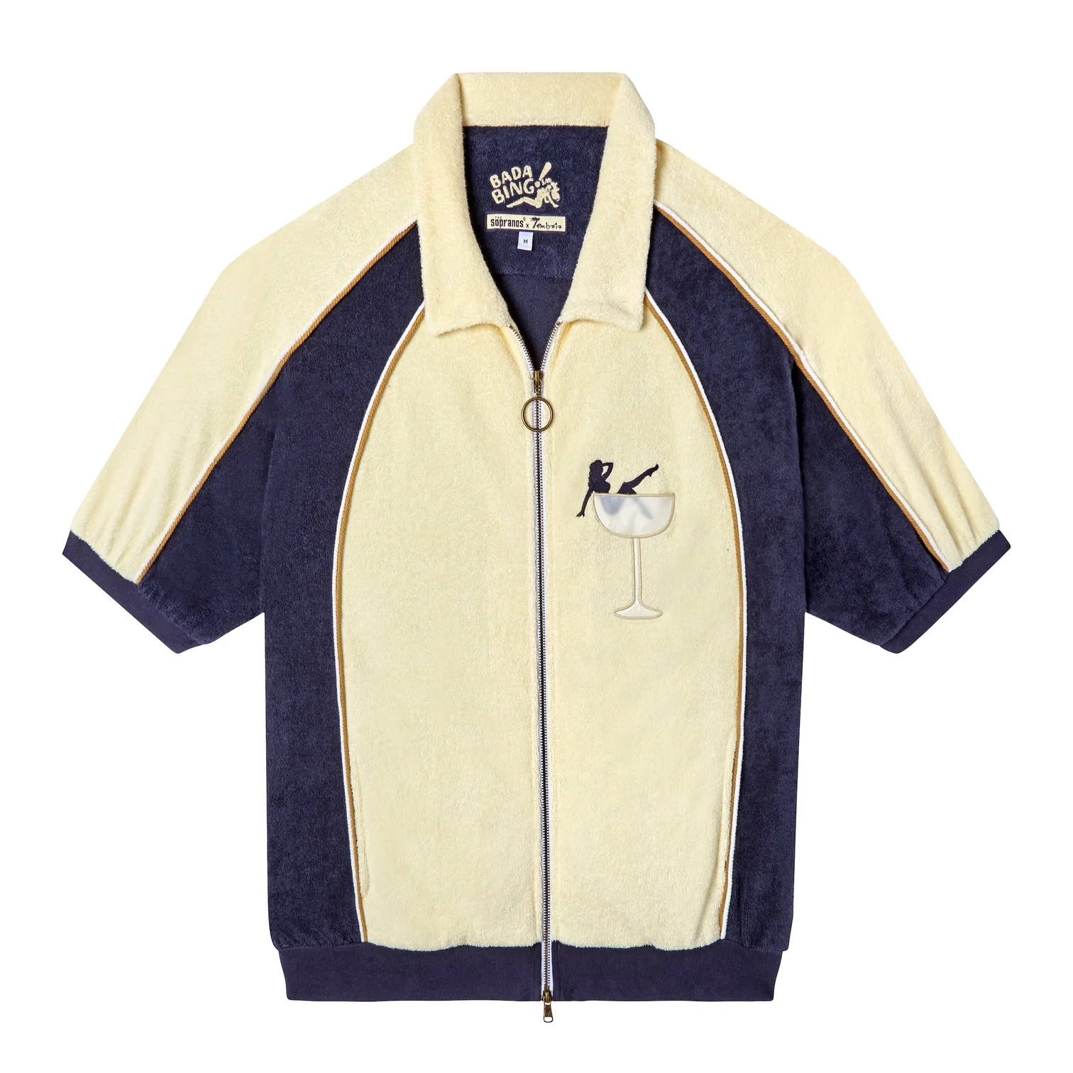 Short-sleeved zip-up shirt with a martini glass embroidery on the front. It features a retro design with contrasting panels