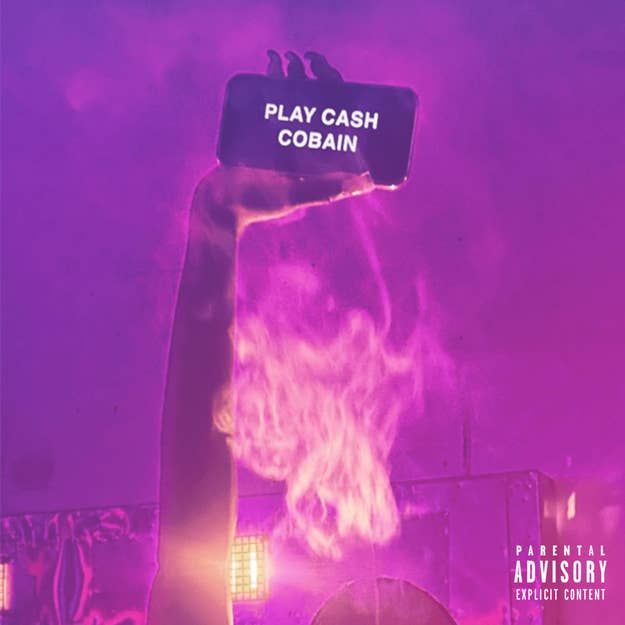 A hand holds a phone with the text "PLAY CASH COBAIN" against a smoky background. The image includes a "Parental Advisory Explicit Content" label