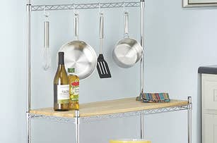product shot of the rack with a crockpot on the bottom utensils hanging on hooks and seasonings on the top with room left to prep food