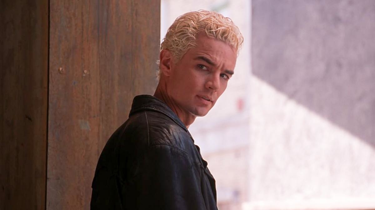James Marsters as Spike from Buffy the Vampire Slayer, wearing a black leather jacket, standing with a serious expression