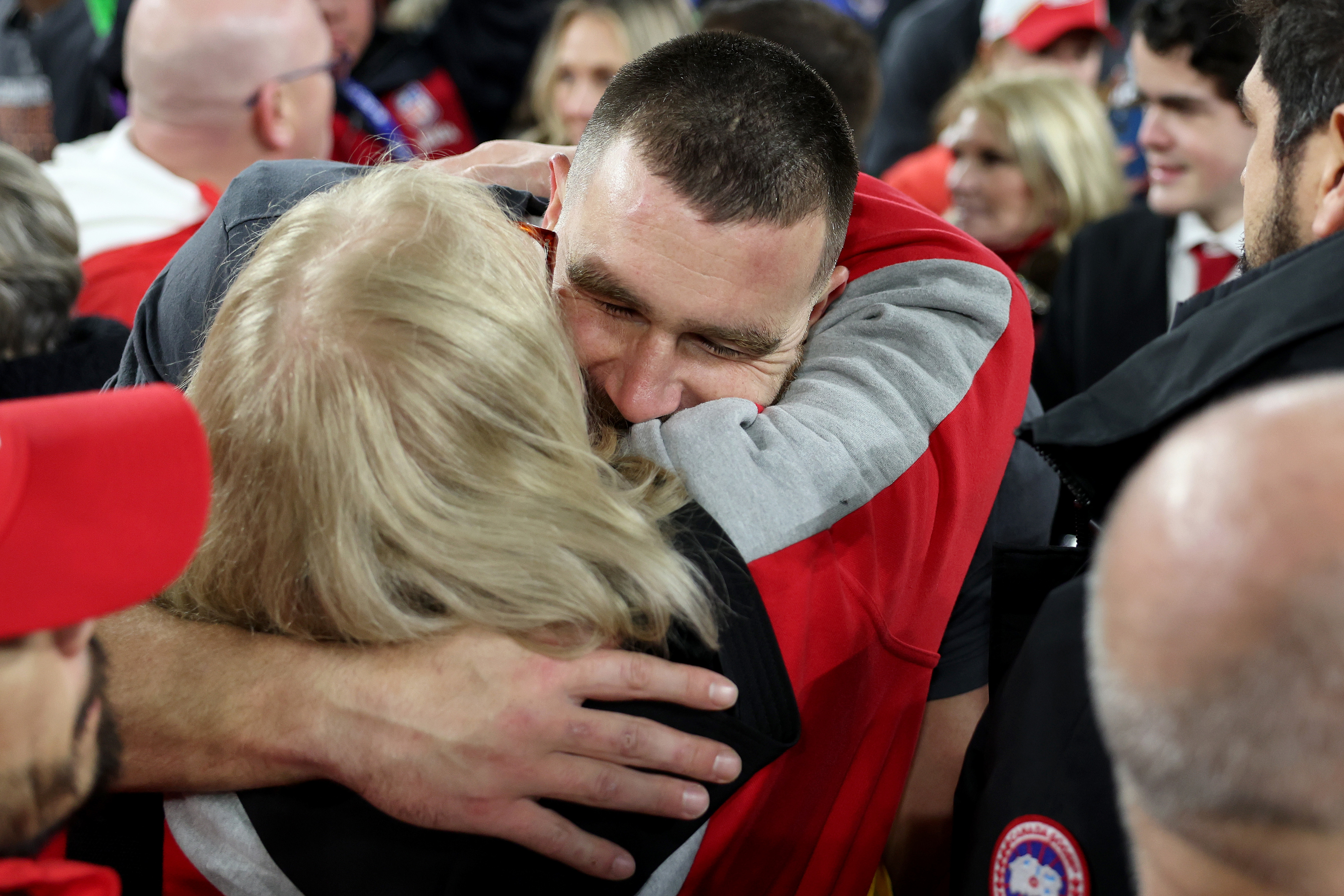 Travis Kelce embraces Donna Kelce in a crowded setting