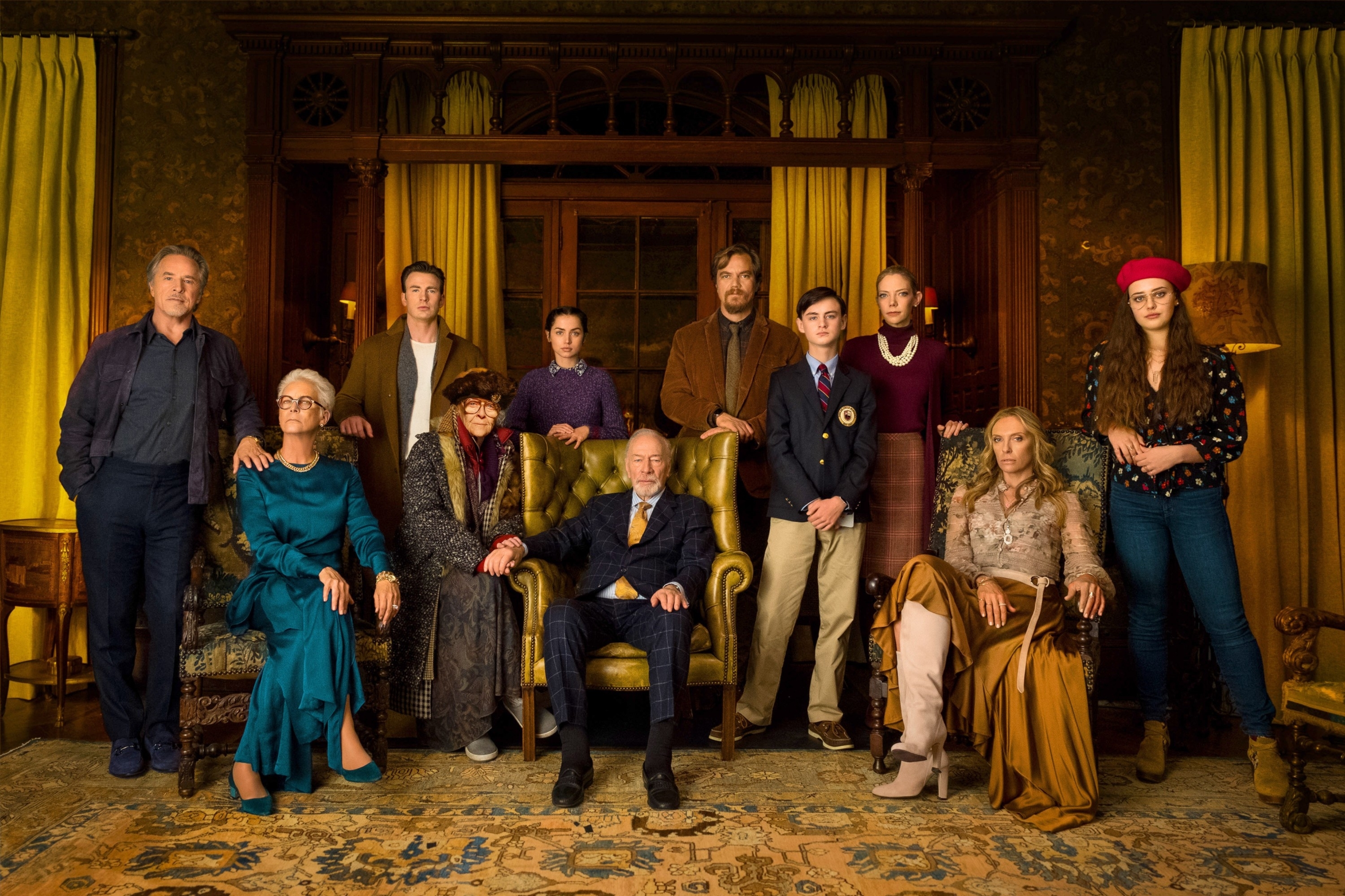 Scene of the &quot;Knives Out&quot; cast posing in formal wear in a luxurious, vintage living room setting