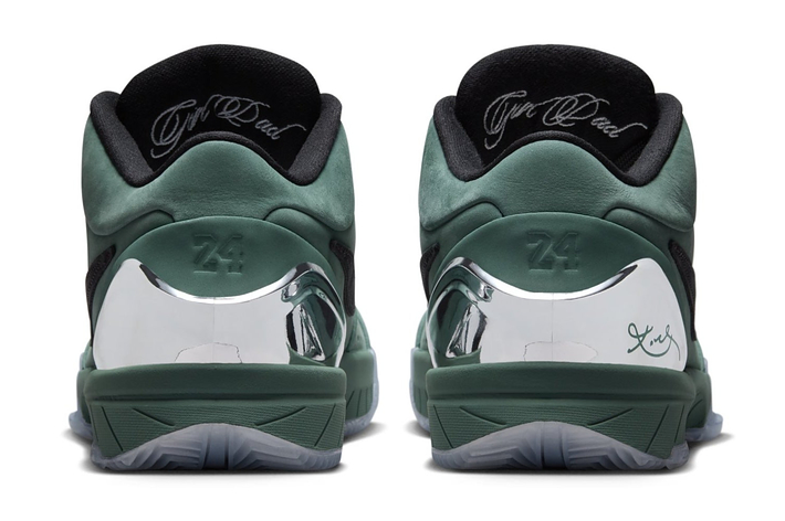 Back view of a pair of green and metallic silver sneakers featuring the number 24 and signatures on the heel