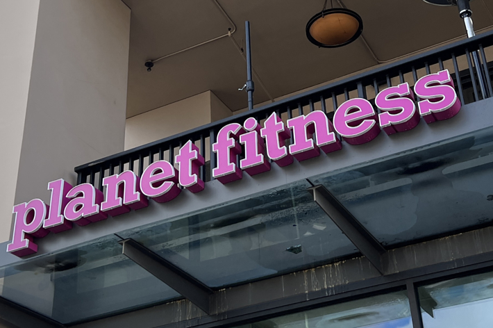 Sign for Planet Fitness gym on a building facade