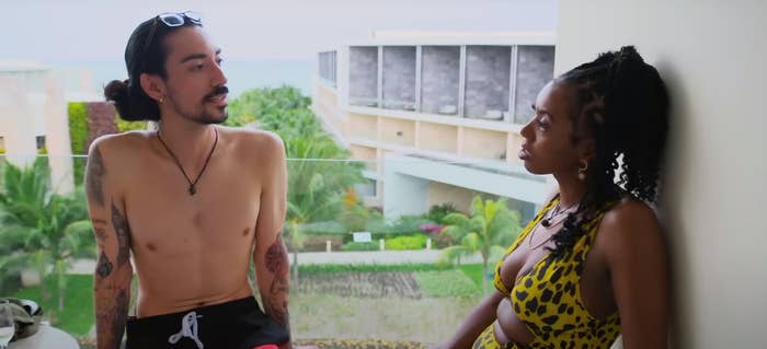 Lauren Goodger and Orion Martzloff, from "Married at First Sight", have a conversation on a balcony with lush greenery in the background