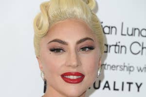 Lady Gaga wears a strapless gown, dramatic makeup, and a sparkling diamond necklace at a formal event